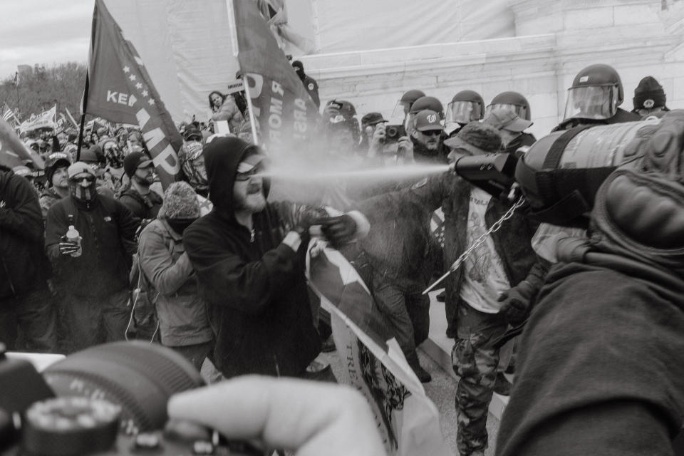 A pro-Trump rioter is pepper sprayed by an officer outside of the Capitol.<span class="copyright">Christopher Lee for TIME</span>