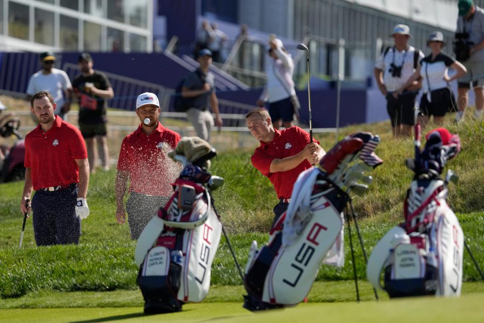 United States' Jordan Spieth, right chips out of a bunker on the 16th during practice round ahead of the Ryder Cup at the Marco Simone Golf Club in Guidonia Montecelio, Italy, Tuesday, Sept. 26, 2023.