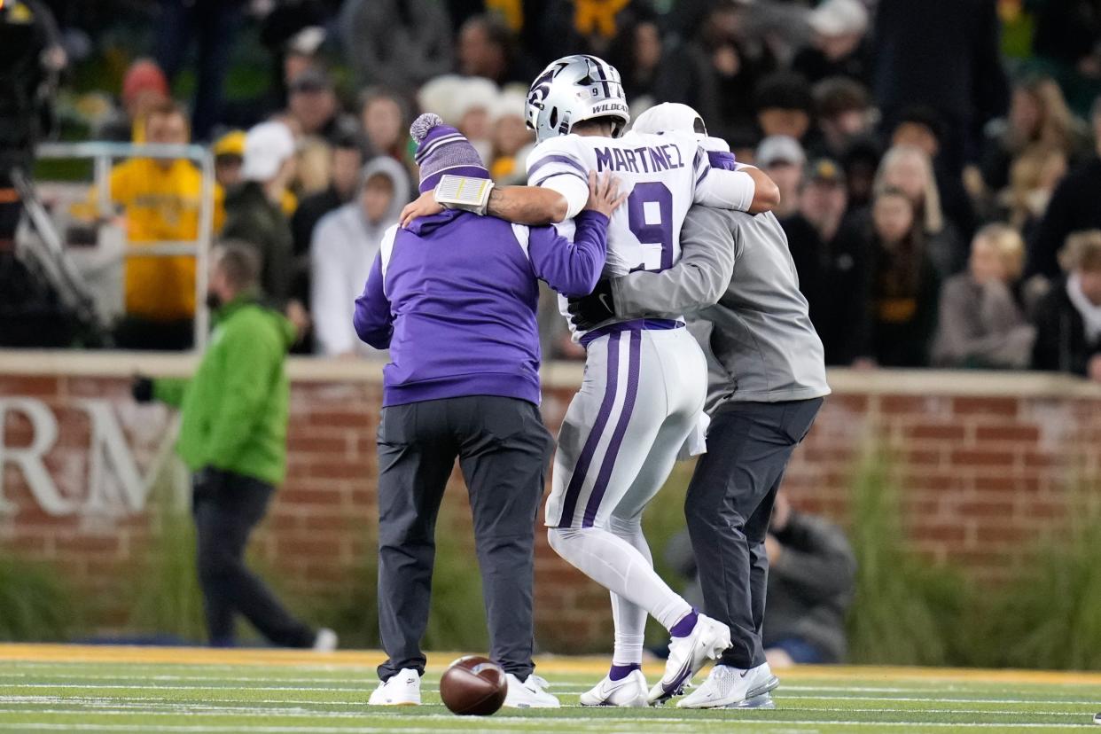 Kansas State Wildcats quarterback Adrian Martinez (9) is helped off the field after being injured against the Baylor Bears last week