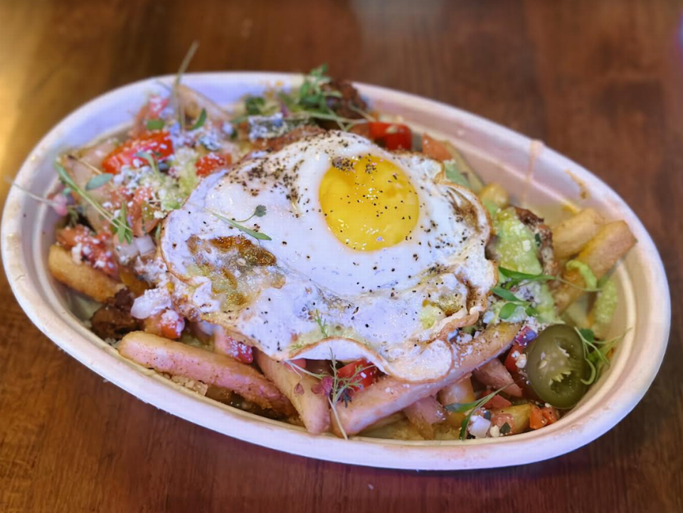 The loaded fries bowl from Que Fresa Taqueria + Bar topped with steak, chorizo, pico de gallo, queso and more.
