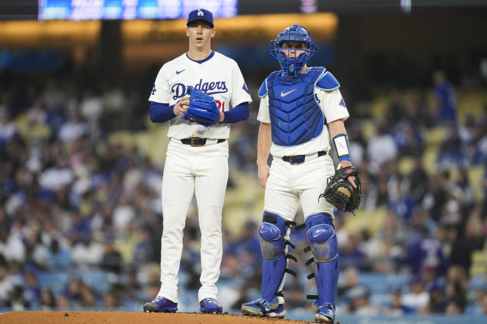 Los Angeles Dodgers starting pitcher Walker Buehler (21) and catcher Will Smith (16) stand on the mound during the third inning of a baseball game agains the Colorado Rockies in Los Angeles, Friday, May 31, 2024. (AP Photo/Ashley Landis)