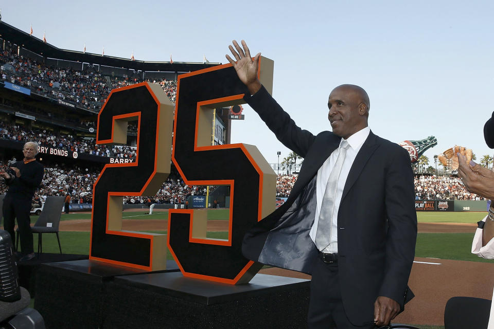 Former San Francisco Giants player Barry Bonds waves during a ceremony to retire his jersey number before a baseball game between the Giants and the Pittsburgh Pirates in San Francisco, Saturday, Aug. 11, 2018. (Lachlan Cunningham/Pool Photo via AP)