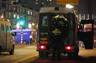 Police officers block a road during a nation-wide curfew in Amsterdam, Netherlands, Tuesday, Jan. 26, 2021. The Netherlands entered its toughest phase of anti-coronavirus restrictions to date, imposing a nationwide night-time curfew from 9 p.m. until 4:30 a.m. which started Saturday Jan. 23, 2021, in a bid to control the COVID-19 infection rate. (AP Photo/Peter Dejong)