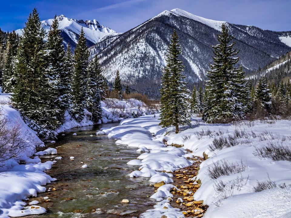 Winter landscape of Colorado San Juan mountains and alpine forest covered with freshly fallen snow.
