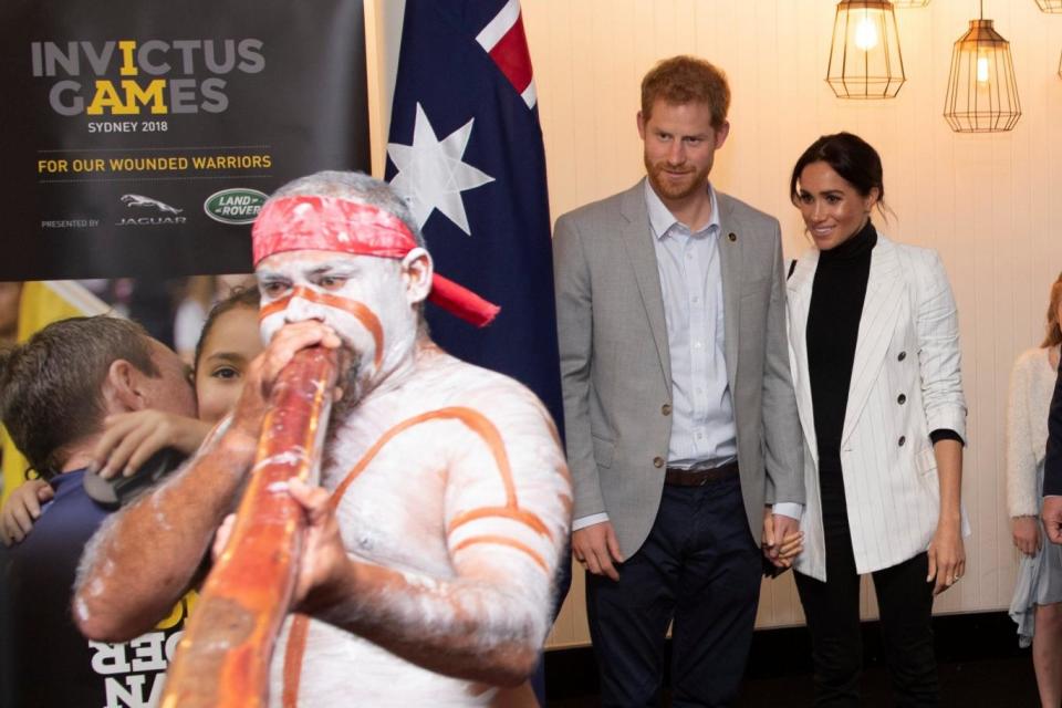 Harry and Meghan watch a performer at a lunchtime reception hosted by the Prime Minister (REUTERS)