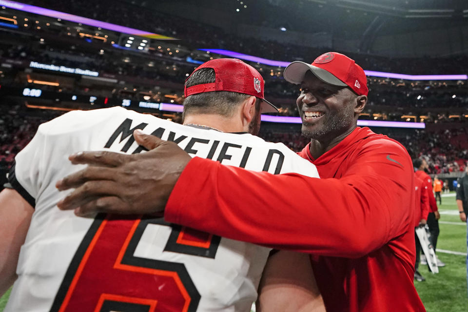 Tampa Bay Buccaneers head coach Todd Bowles celebrates with quarterback Baker Mayfield after defeating the Atlanta Falcons in an NFL football game, Sunday, Dec. 10, 2023, in Atlanta. (AP Photo/Brynn Anderson)