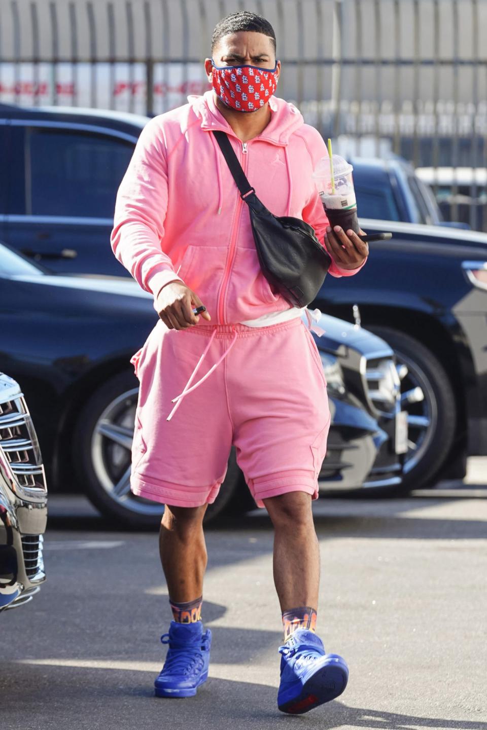 <p>Nelly arrives at the<i> Dancing with the Stars </i>rehearsal studio in a pink sweatsuit and purple sneakers on Wednesday in L.A. </p>