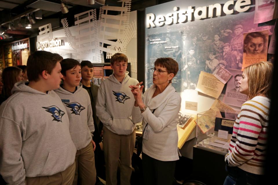 Gallery guide Pat Hopson leads a class of eighth-graders from St. Joseph School at the Holocaust & Humanity Center inside the Cincinnati Museum Center in Cincinnati in February 2020.