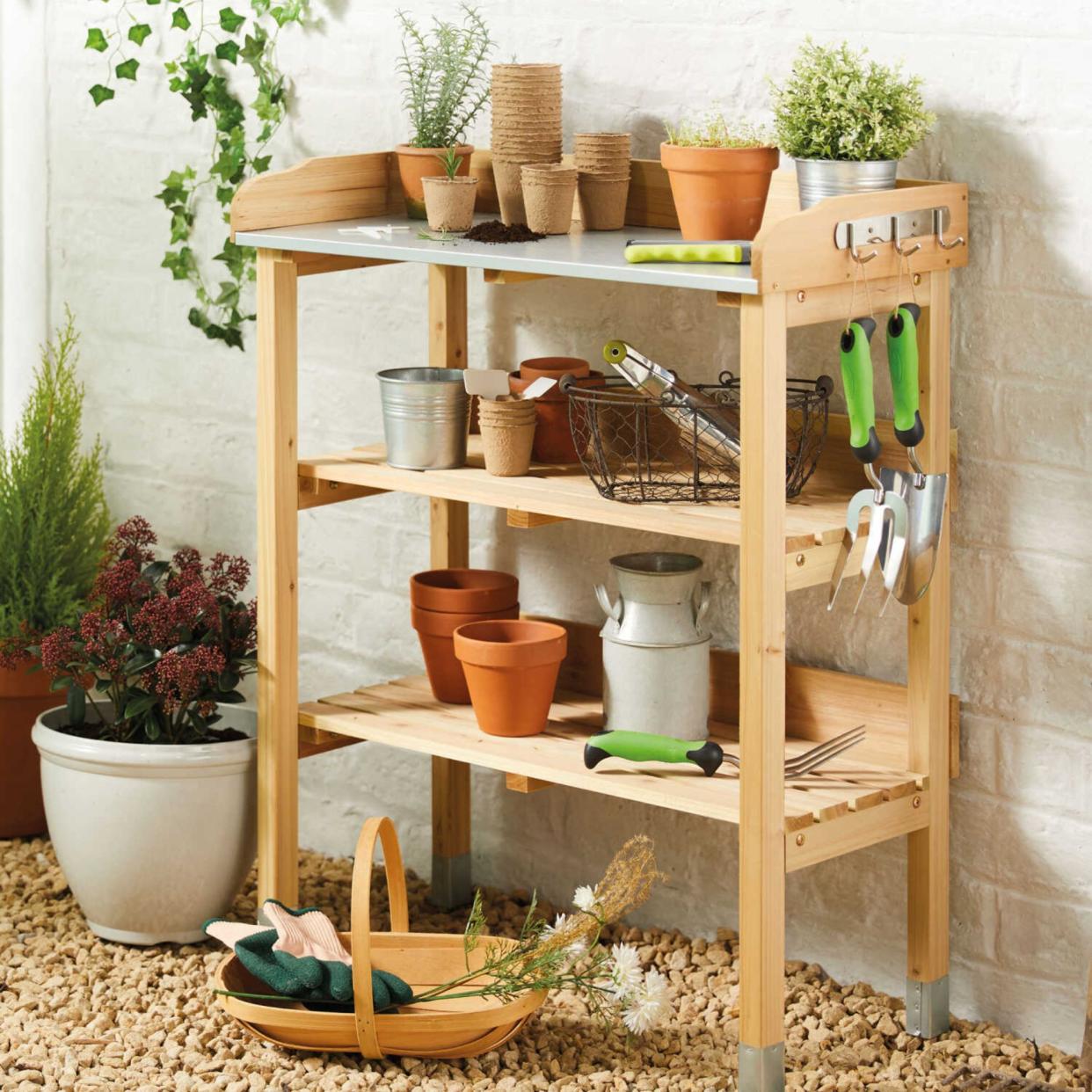  Aldi potting bench filled with various gardening items. 