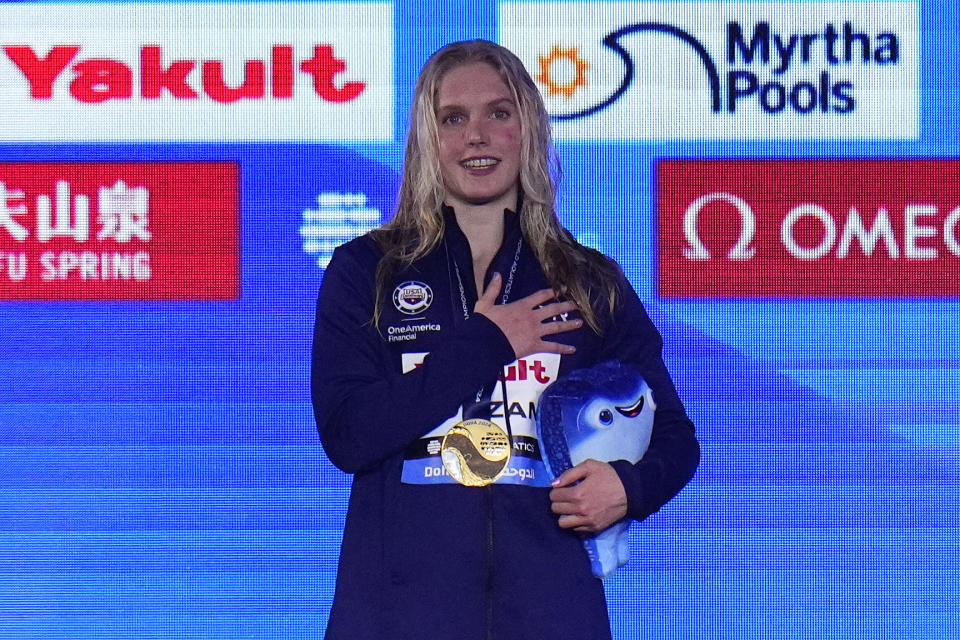 Claire Curzan of the United States stands at the podium after winning gold medal in the in the women's 50-meter backstroke final at the World Aquatics Championships in Doha, Qatar, Thursday, Feb. 15, 2024. (AP Photo/Hassan Ammar)