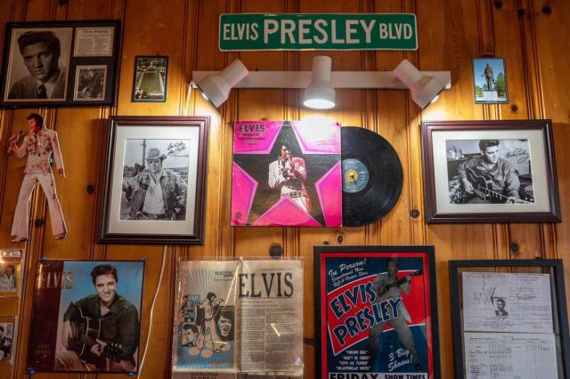 Elvis Presley memorabilia decorates a wall in the game room at the Elvis Retreat House. The front page of The Kansas City Times from the day Elvis died in 1977 is also displayed.