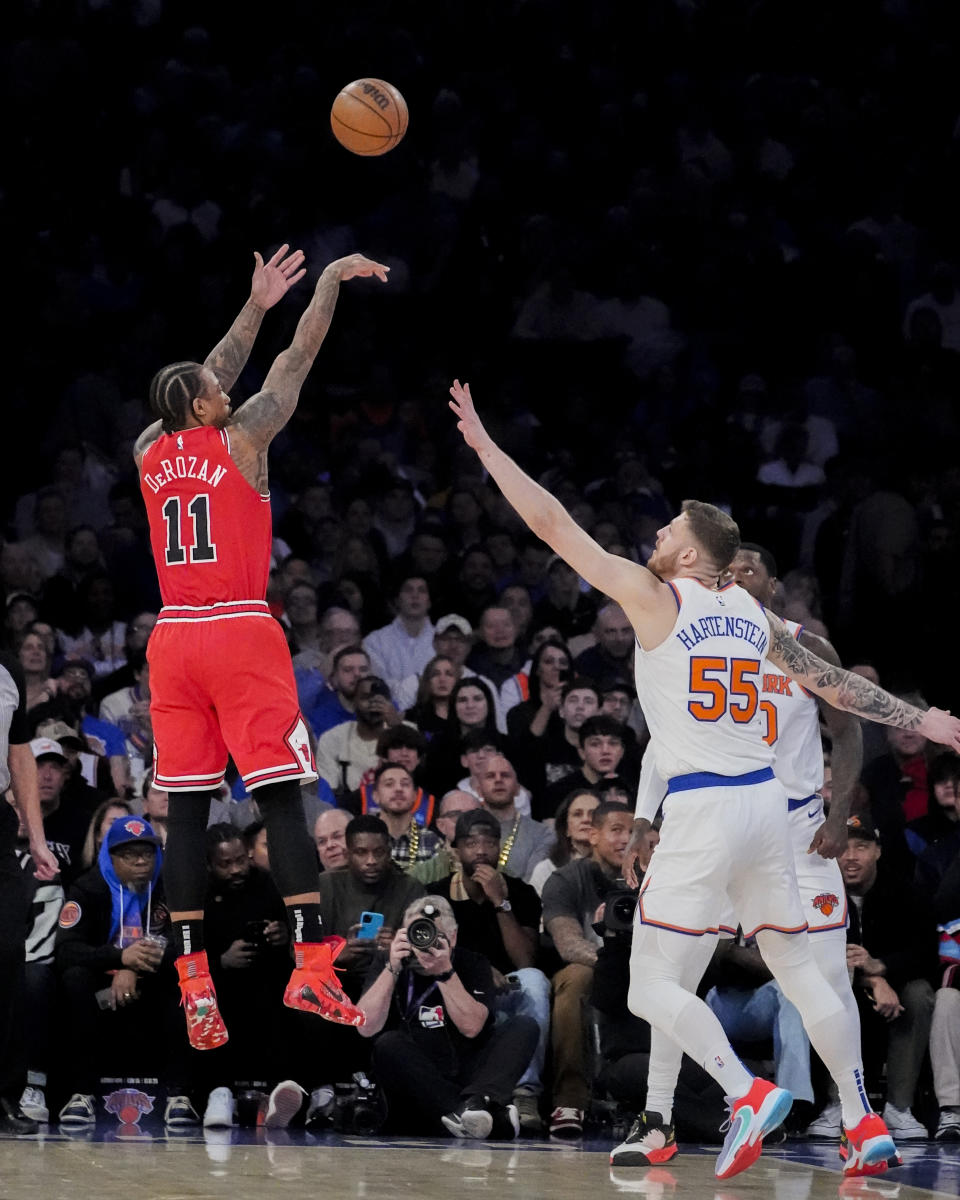 Chicago Bulls forward DeMar DeRozan (11) shoots the ball over New York Knicks center Isaiah Hartenstein (55) during the first half of an NBA basketball game in New York, Wednesday, Jan. 3, 2024. (AP Photo/Peter K. Afriyie)