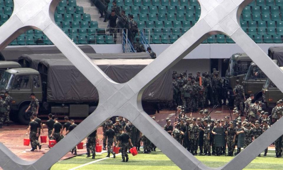 Chinese paramilitary police officers go through drills at the Shenzhen Bay stadium on Sunday.