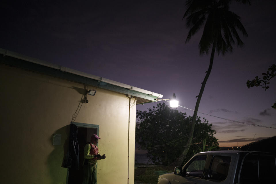 Lance Biggart, a local fisherman, stands after a day of work in the village of Belle Garden on the Caribbean island of Tobago, Trinidad and Tobago, Thursday, Jan. 20, 2022. Biggart and a colleague towed a Mauritanian boat back to shore after it was found on May 28, 2021. Biggart remembers being puzzled by how the boat could have survived Atlantic swells. “A wave came, and the boat rocked so, so badly,” he recalls. (AP Photo/Felipe Dana)