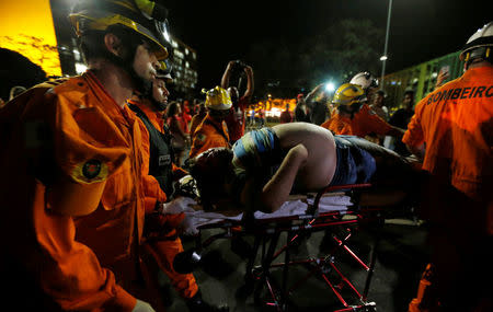 Rescue workers helps an injured demonstrator during a protest against the impeachment of President Dilma Rousseff in Brasilia, Brazil, May 11, 2016. REUTERS/Paulo Whitaker