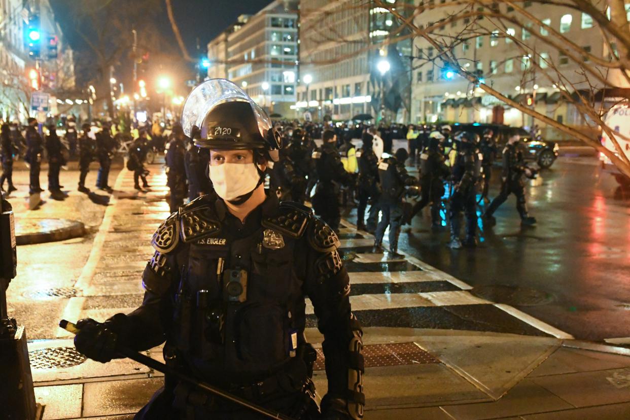 <p>File image: A police officer in riot gear stands guard as protesters gather near Black Lives Matter Plaza during a protest on 12 December , 2020 in Washington</p> (Getty images)