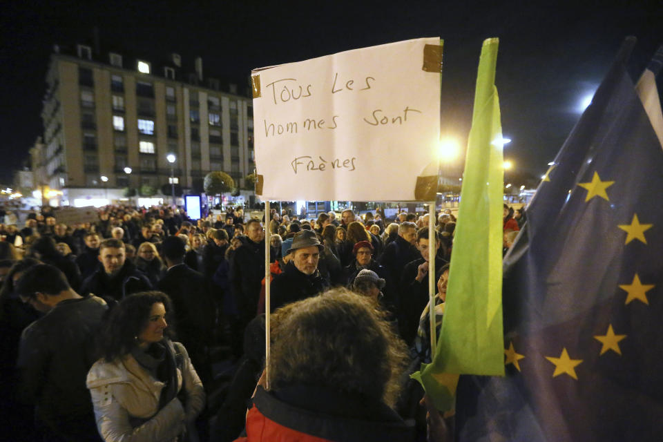 Protesters against anti-Semitism gather in Rennes, western France, Tuesday, Feb. 19, 2019, after a series of anti-Semitic acts that shocked the country. French residents and public officials from across the political spectrum geared up Tuesday for nationwide rallies against anti-Semitism following a series of anti-Semitic acts, including the swastikas painted on about 80 gravestones at a Jewish cemetery overnight. Banner reads: "All human are brothers". (AP Photo/David Vincent)