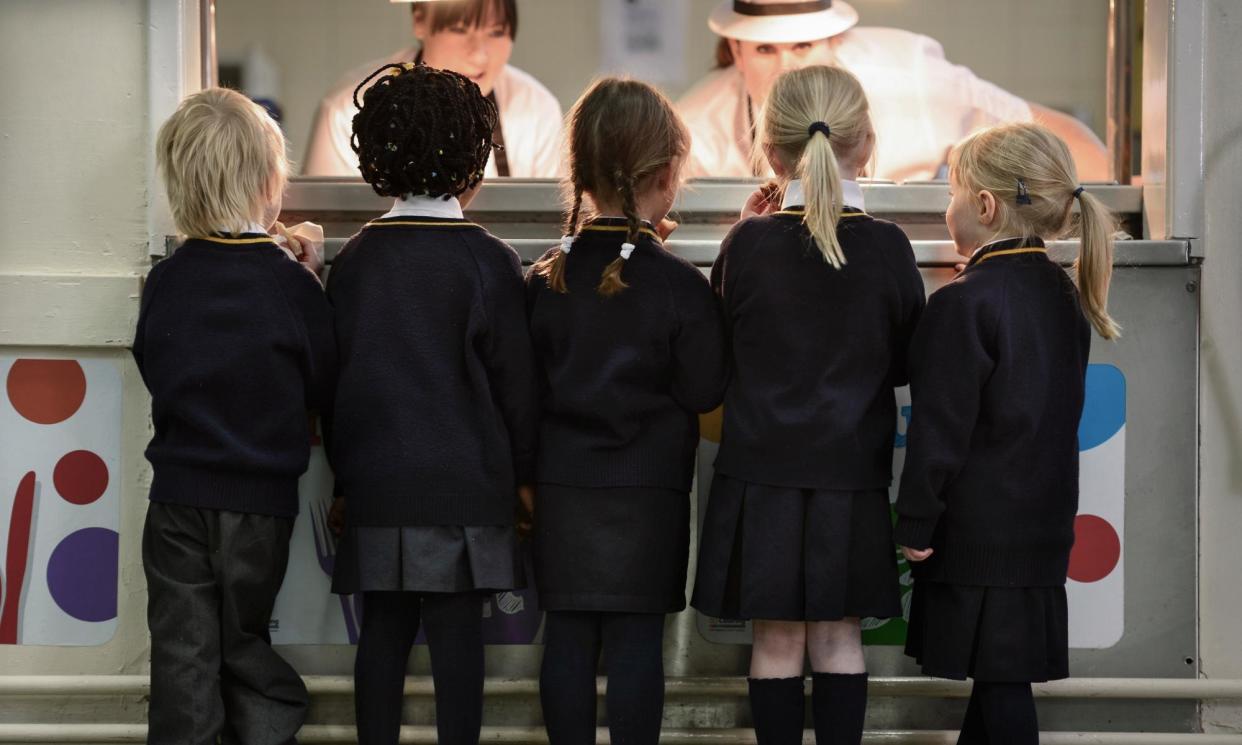 <span>Children queue for food at a primary school in Newcastle-under-Lyme.</span><span>Photograph: Adrian Sherratt/Alamy</span>
