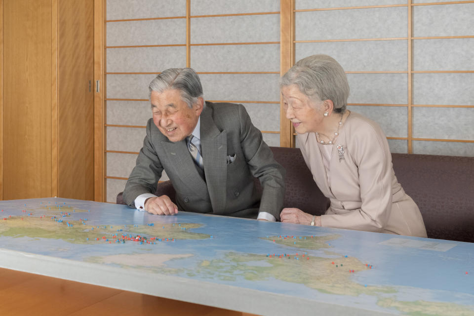 In this Monday, Dec. 10, 2018, photo released on Friday, Dec. 21, 2018, by the Imperial Household Agency of Japan, Japan's Emperor Akihito, left, and Empress Michiko, right, look at a map at the Imperial residence of the Imperial Palace in Tokyo. Emperor Akihito, who turns 85 on Sunday, Dec. 23, and will abdicate this spring, says he feels relieved to see the era of his reign coming to an end without having seen his country at war. (The Imperial Household Agency of Japan via AP)