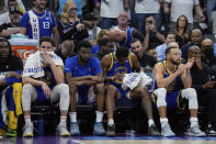 Golden State Warriors guards Klay Thompson, second from left, and Stephen Curry, second from right, sit on the bench during the second half of the team's NBA basketball play-in tournament game against the Sacramento Kings, Tuesday, April 16, 2024, in Sacramento, Calif. (AP Photo/Godofredo A. Vásquez)