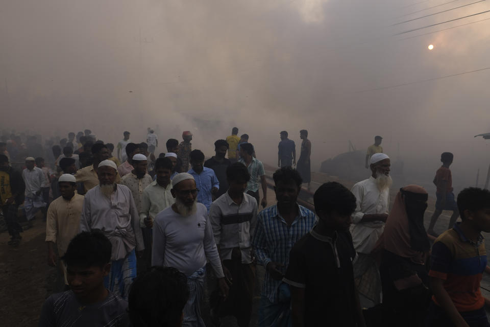 Rohingya refugees look on after a major fire in their Balukhali camp at Ukhiya in Cox's Bazar district, Bangladesh, Sunday, March 5, 2023. A massive fire raced through a crammed camp of Rohingya refugees in southern Bangladesh on Sunday, leaving thousands homeless, a fire official and the United Nations said. (AP Photo/Mahmud Hossain Opu)