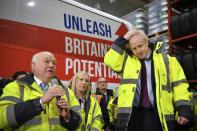 Britain's Prime Minister Boris Johnson, right, stands by as CEO Alan Ferguson, talks during a question and answer session, part of a General Election campaign visit to Ferguson's Transport in Washington, England, Monday, Dec. 9, 2019. Britain goes to the polls on Dec. 12. (Ben Stansall/Pool Photo via AP)