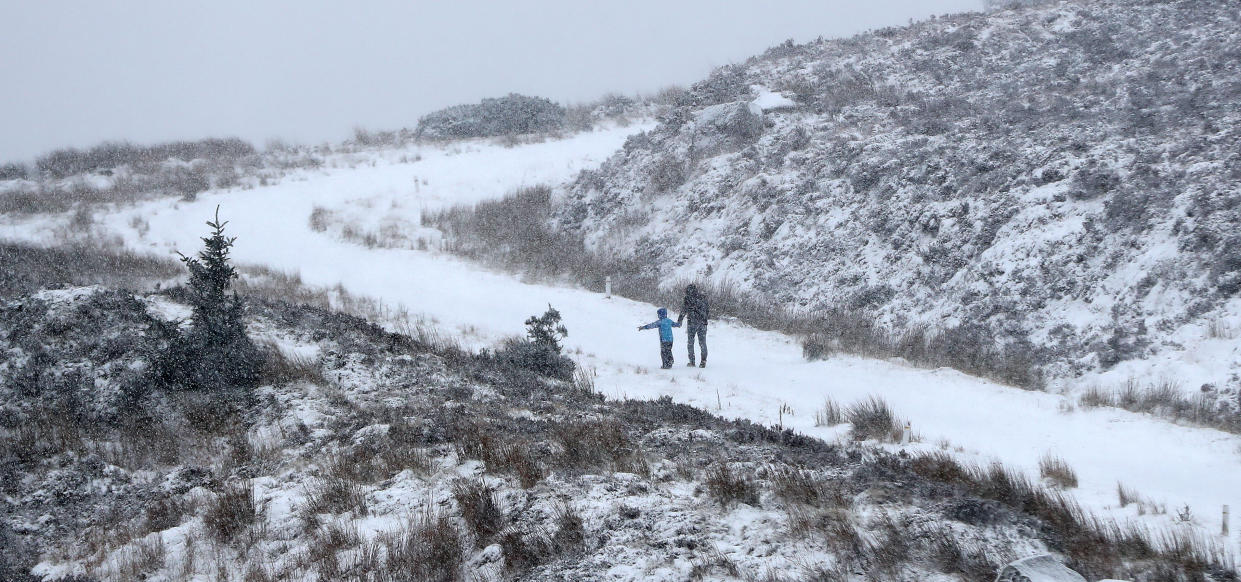 People walking in the snow in the Wicklow Gap, Co Wicklow. PA Photo. Picture date: Sunday December 15, 2019. See PA story WEATHER Rain . Photo credit should read: Niall Carson/PA Wire                          