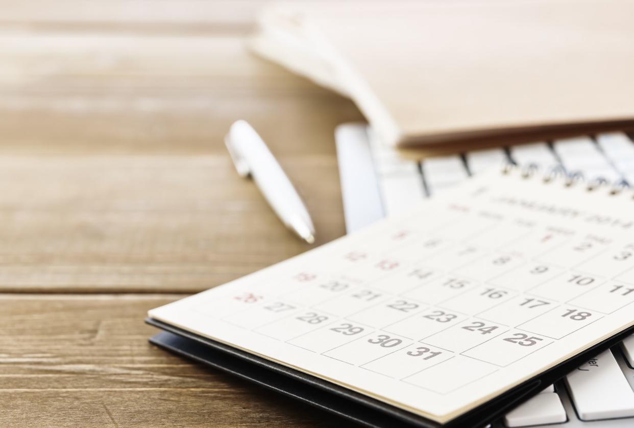 Calendar and Work tools on office desk table. With copy space.