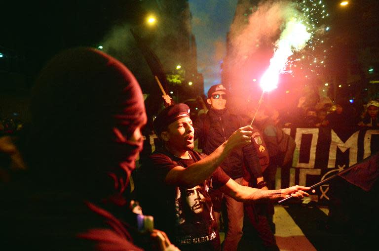 A man wearing a T-shirt with the portrait of Argentine-born revolutionary leader Ernesto "Che" Guevara takes part in a demonstration for the Guy Fawkes World Day in Rio de Janeiro, Brazil on November 5, 2013