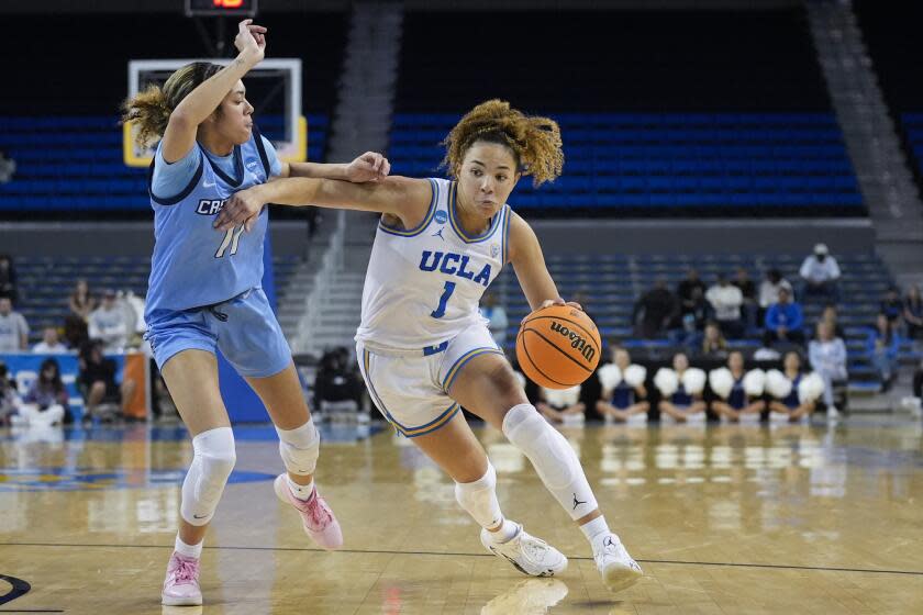 UCLA guard Kiki Rice (1) dribbles past Creighton guard Kiani Lockett (11) during the second half.