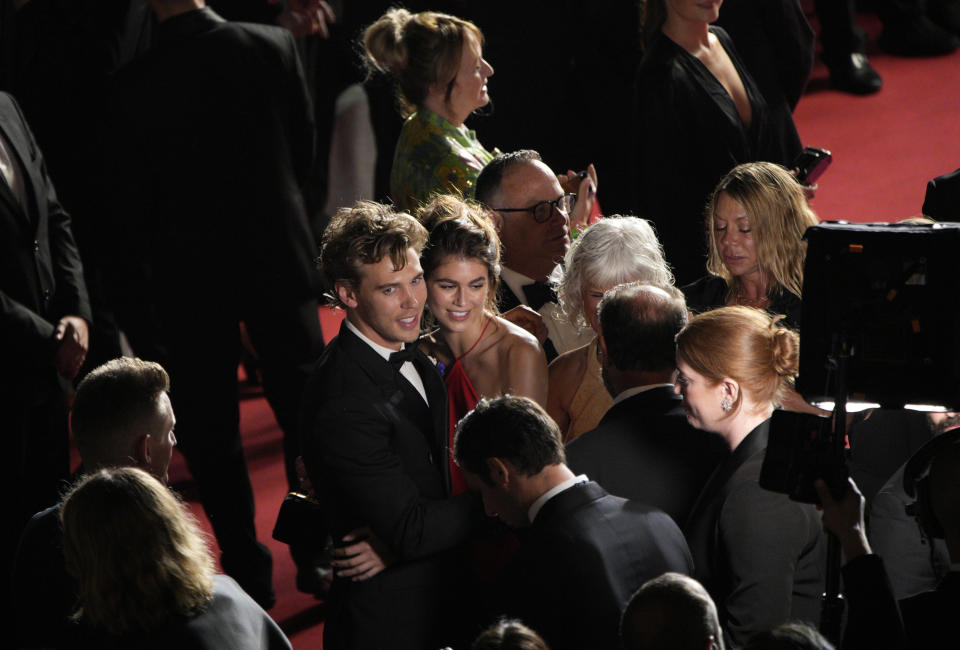 Austin Butler, left, and Kaia Gerber pose for photographers after departing the premiere of the film 'Elvis' at the 75th international film festival, Cannes, southern France, Wednesday, May 25, 2022. (AP Photo/Daniel Cole)