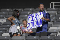 A disappointed fan holds a sign calling for the firing of Dave Gettleman, senior vice president of the New York Giants, after their defeat against the Atlanta Falcons after an NFL football game, Sunday, Sept. 26, 2021, in East Rutherford, N.J. (AP Photo/Bill Kostroun)