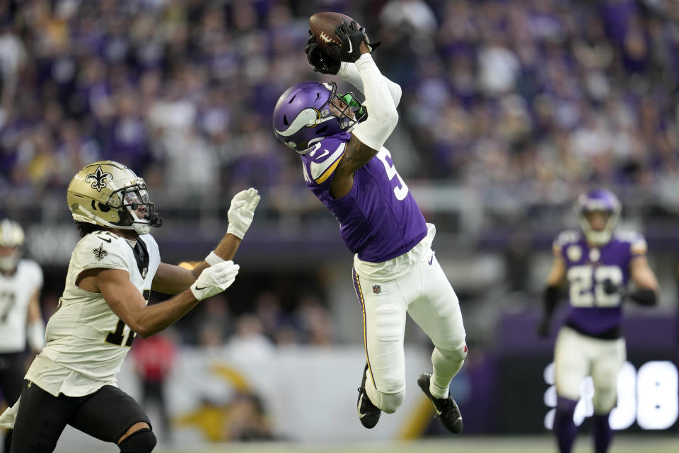 Minnesota Vikings cornerback Mekhi Blackmon (5) intercepts a pass intended for New Orleans Saints wide receiver Chris Olave, left, during the second half of an NFL football game Sunday, Nov. 12, 2023, in Minneapolis. (AP Photo/Abbie Parr)