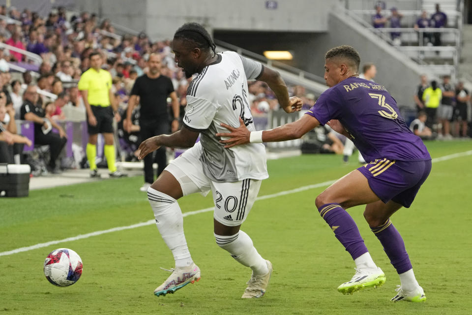 Toronto FC's Ayo Akinola (20) kicks the ball out of bounds as he is defended by Orlando City's Rafael Santos (3) during the first half of an MLS soccer match Tuesday, July 4, 2023, in Orlando, Fla. (AP Photo/John Raoux)