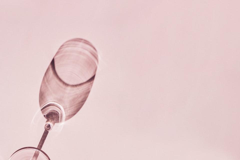 shadow from wine glass on pink background