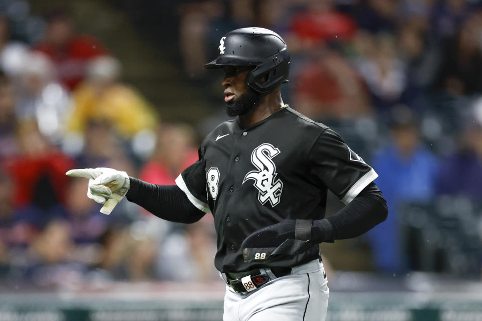 Chicago White Sox's Luis Robert celebrates after scoring on a double by Jose Abreu during the sixth inning of a baseball game against the Cleveland Guardians, Saturday, Aug. 20, 2022, in Cleveland. (AP Photo/Ron Schwane)