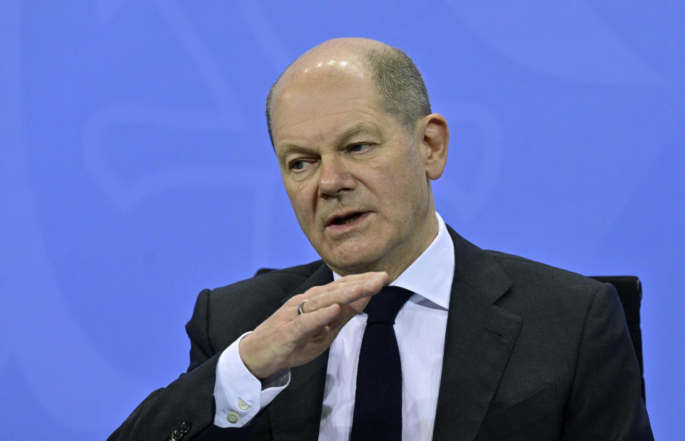 Finance Minister Olaf Scholz, who is expected to be elected chancellor by a center-left coalition next week, attends a press conference following a meeting with the heads of government of Germany's federal states at the Chancellery in Berlin, Thursday, Dec. 2, 2021. Merkel said Thursday that people who aren't vaccinated will be excluded from nonessential stores, cultural and recreational venues, and parliament will consider a general vaccine mandate, as part of an effort to curb coronavirus infections that again topped 70,000 newly confirmed cases in a 24-hour period. (John Macdougall/Pool Photo via AP)