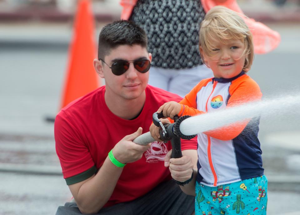 Kids play firefighters during the fifth annual Pensacola Beach Firefighters Challenge. The event tested the strength, agility, teamwork, and skills of firefighters as well as provided a fun, family friendly event for participants and the public. 