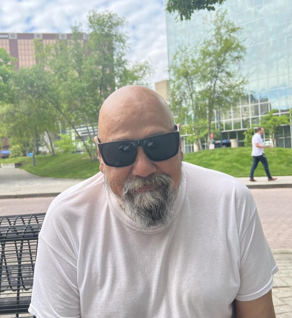 Roger Rodriguez, 71, sits for a portrait near Rosa Parks Circle in downtown Grand Rapids, Mich., on Tuesday, May 30, 2023.