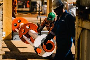 Engineers inspect a section of the riser pipe aboard the Hidden Gem.