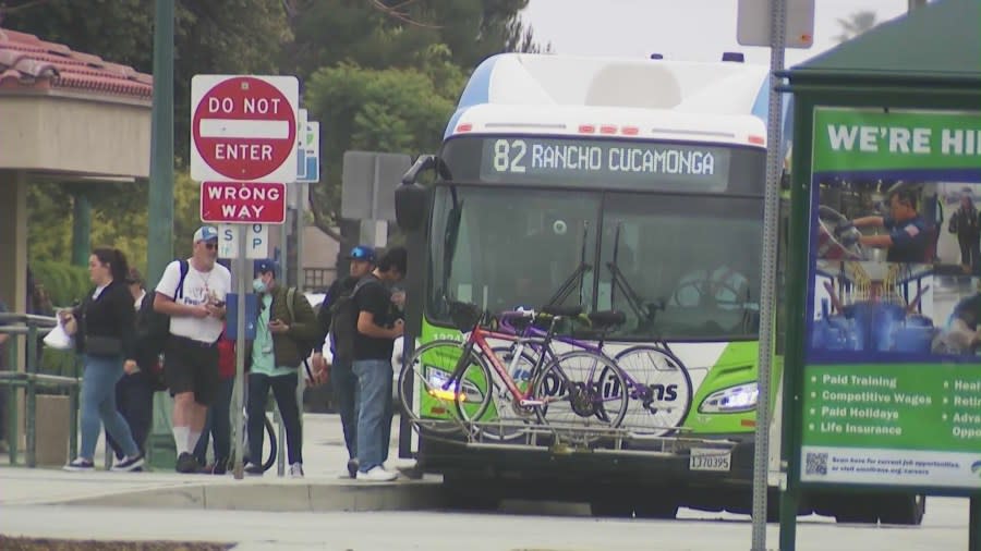Riders waiting to board a Metro bus in Fontana, California. (KTLA)