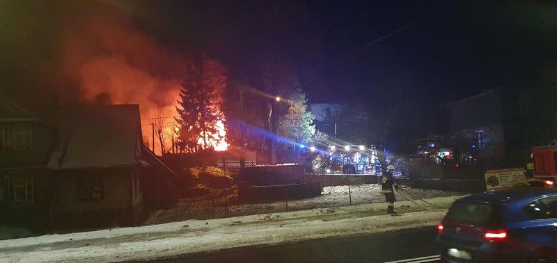 First responders work near the site of a gas explosion that levelled a building in Szczyrk