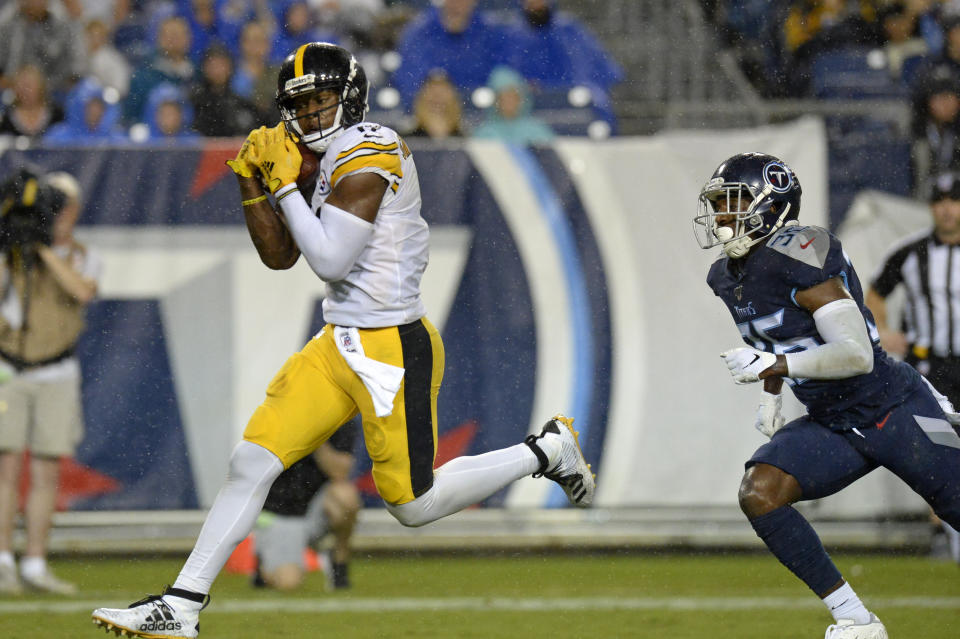 FILE - In this Aug. 25, 2019, file photo, Pittsburgh Steelers wide receiver JuJu Smith-Schuster catches a 17-yard touchdown pass ahead of Tennessee Titans cornerback LeShaun Sims (36) in the first half of a preseason NFL football game in Nashville, Tenn. Smith-Schuster is looking for a big bounce-back this season. (AP Photo/Mark Zaleski, File)