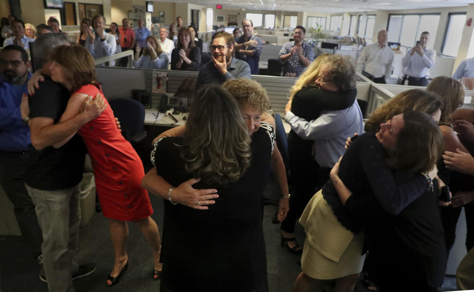 Staff of the South Florida Sun Sentinel celebrate their bittersweet honor Monday, April 15, 2019, in Deerfield Beach, Fla., after winning the Pulitzer Prize for Public Service. The newspaper won for its coverage of the Parkland school shooting. (Carline Jean/South Florida Sun-Sentinel via AP)