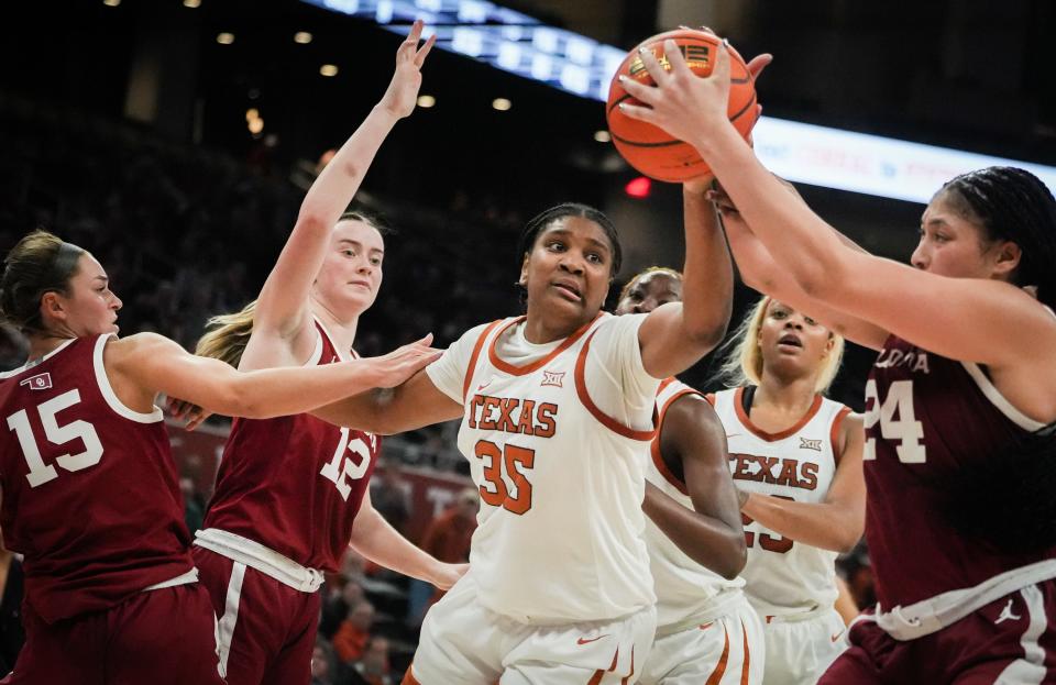 Longhorns forward Madison Booker struggles with Sooners forward Skylar Vann for the rebound during a game at Moody Center in January. The Sooners won the game 91-87.