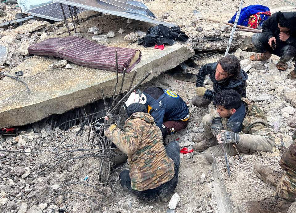 Rescuers search for survivors under the rubble in Jandaris, Syria.