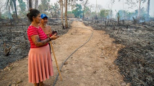 <span class="caption">Members of the Huni Kuin community survey the damage after a fire on August 22. </span> <span class="attribution"><a class="link " href="https://www.facebook.com/huwakaru/posts/732602613865559" rel="nofollow noopener" target="_blank" data-ylk="slk:Centro Huwã Karu Yuxibu via Facebook;elm:context_link;itc:0;sec:content-canvas">Centro Huwã Karu Yuxibu via Facebook</a></span>