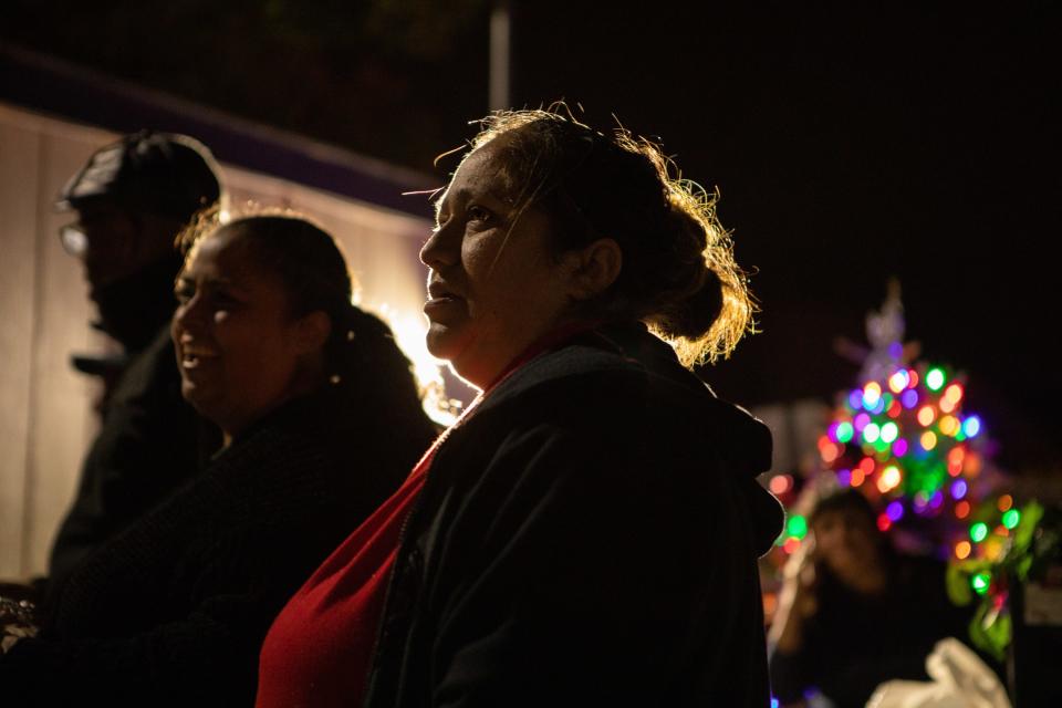 Adela Morales, 45, sings carols during a Christmas celebration at a Project WeHope safe parking lot in East Palo Alto, California, on Dec. 21, 2019.