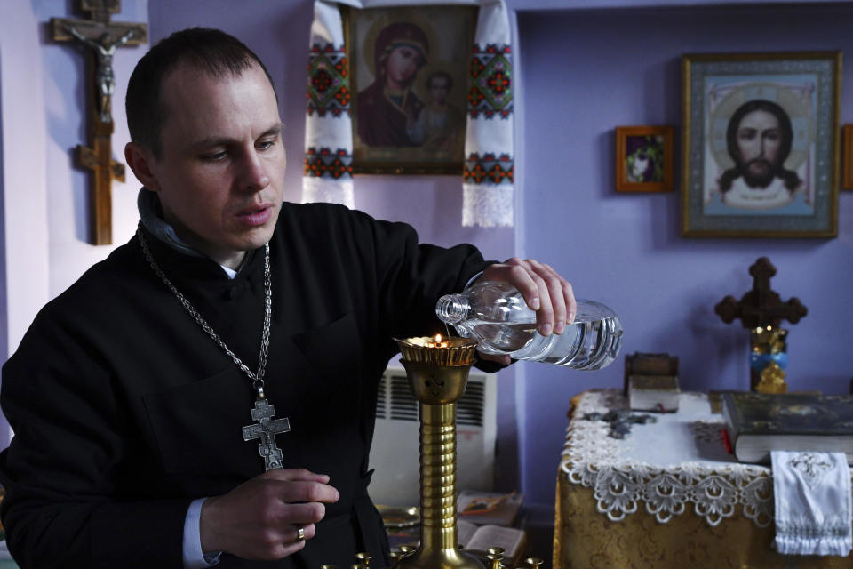 Orthodox priest Alexander Ivlev prepares for a service during the Easter celebration at the Saint Pantaleon church in Kramatorsk, Ukraine, Sunday, April 24, 2022. (AP Photo/Andriy Andriyenko)