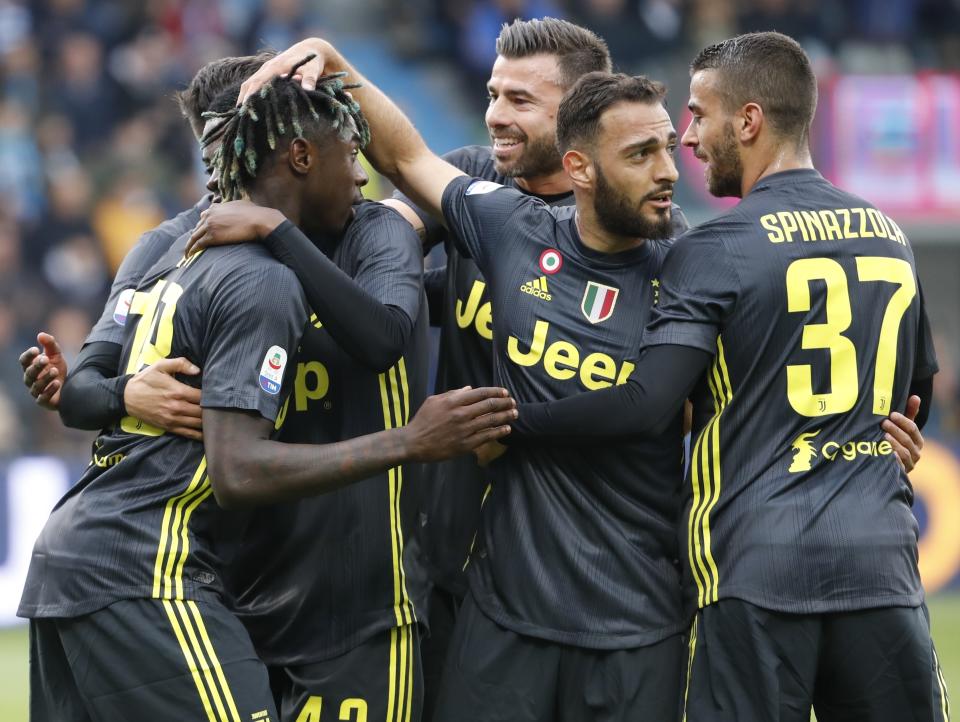 Juventus' Moise Kean, left, celebrates with his teammates after scoring his side's opening goal during the Serie A soccer match between Spal and Juventus, at the Paolo Mazza stadium in Ferrara, Italy, Saturday, April 13, 2019. (AP Photo/Antonio Calanni)